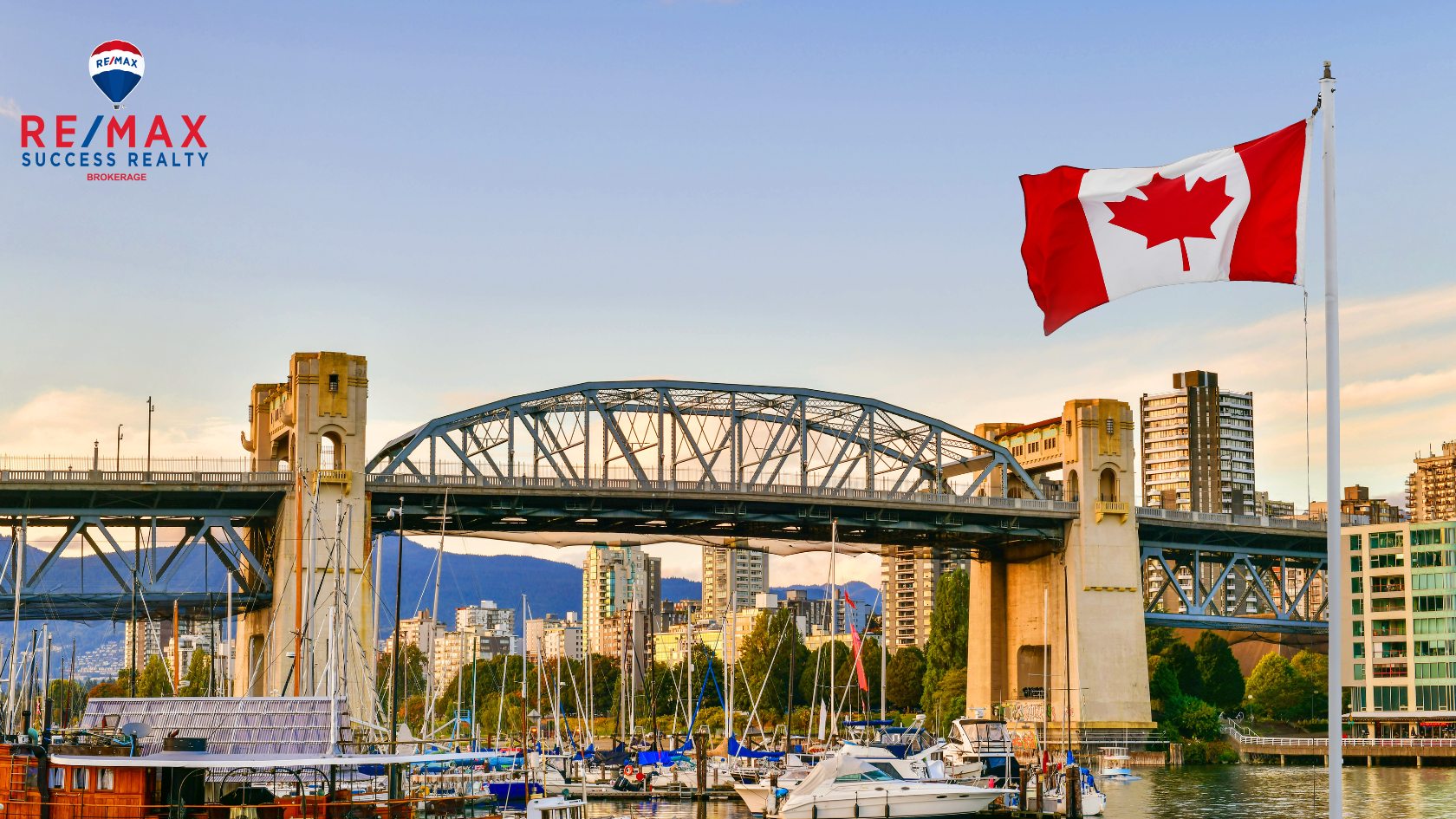 canada flag in front of a bridge with boats on the river