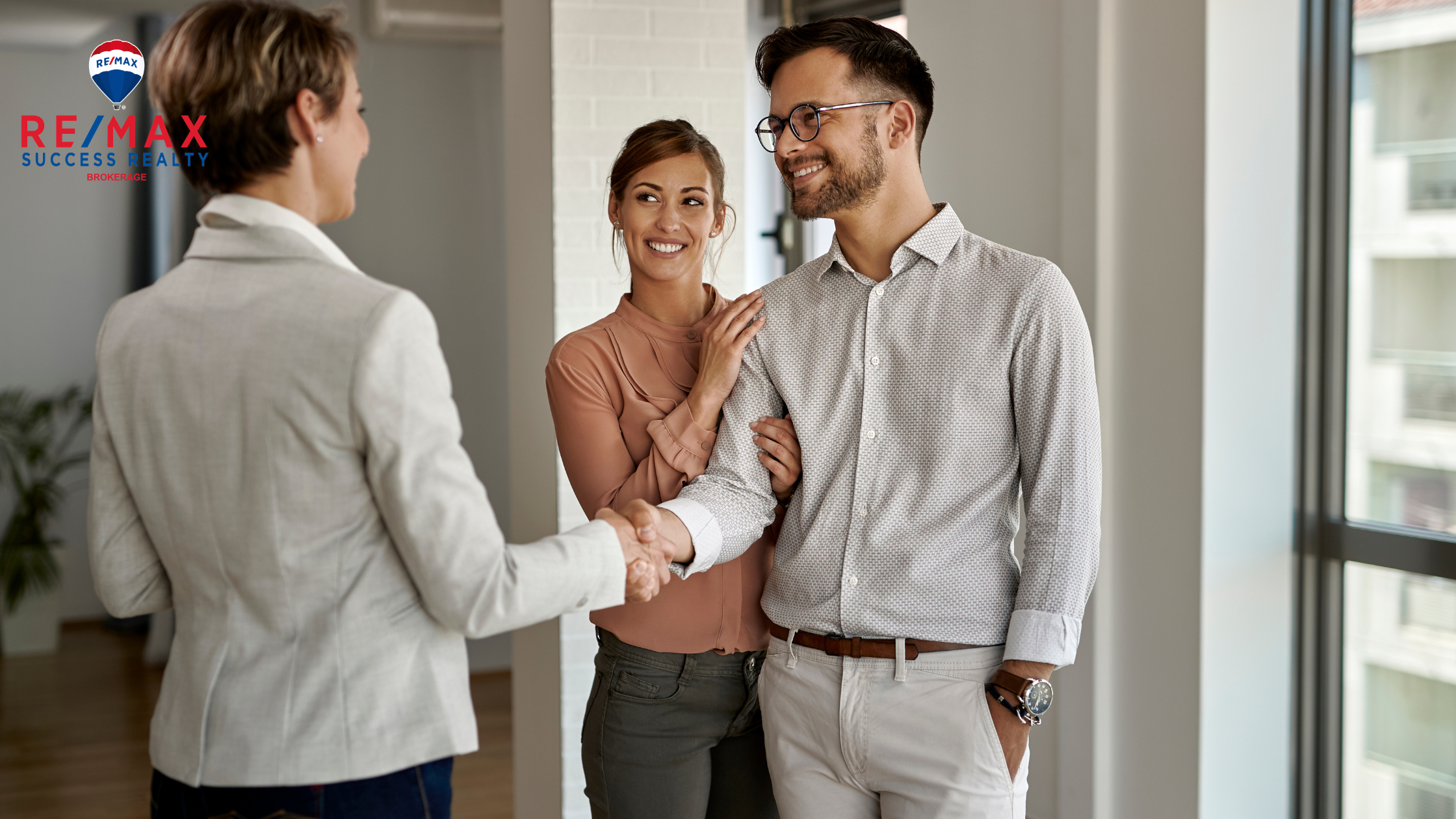 Trusted real estate agent shaking hands with new buyers