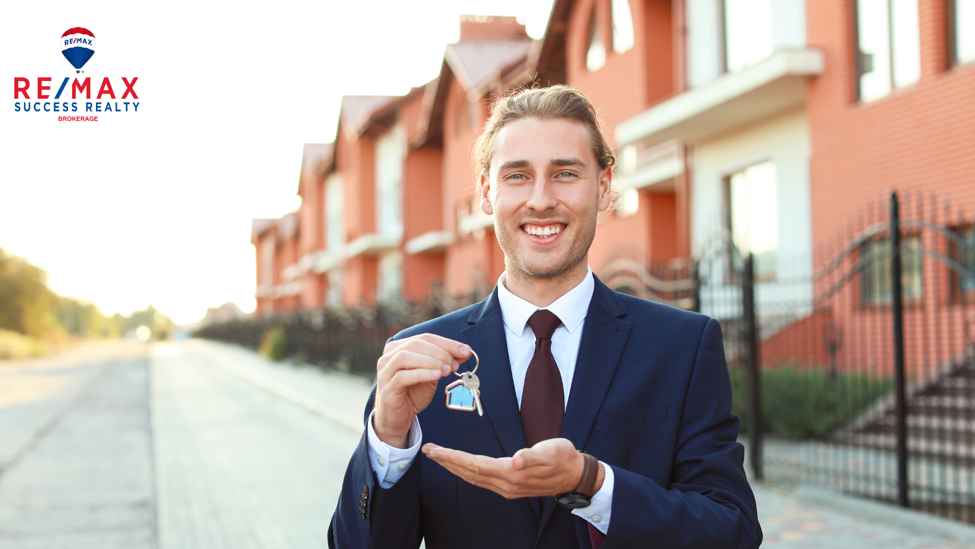 agent holding keys outside of townhomes in Canada
