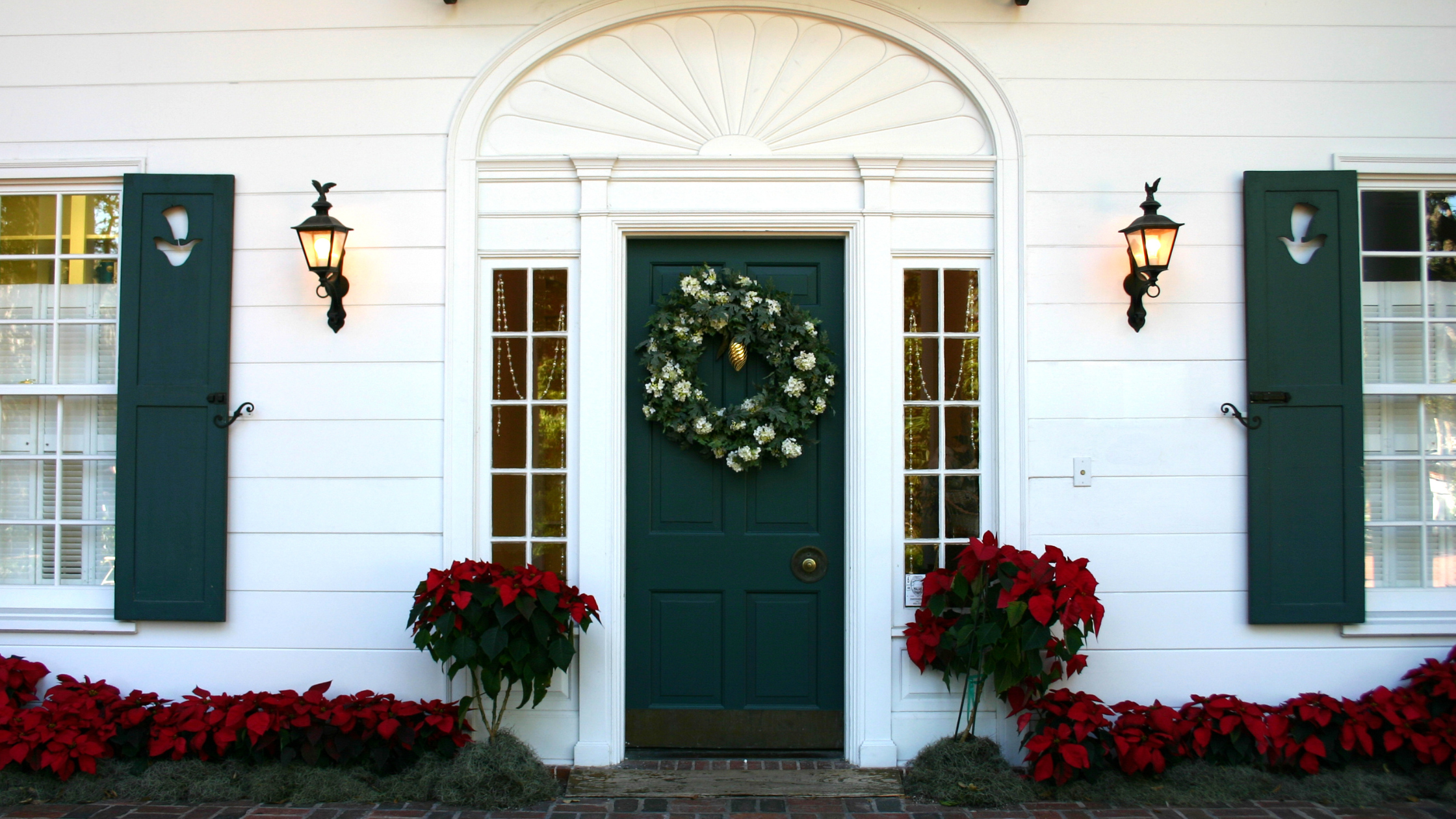 white house with christmas and holiday decorations preparing your home for winter