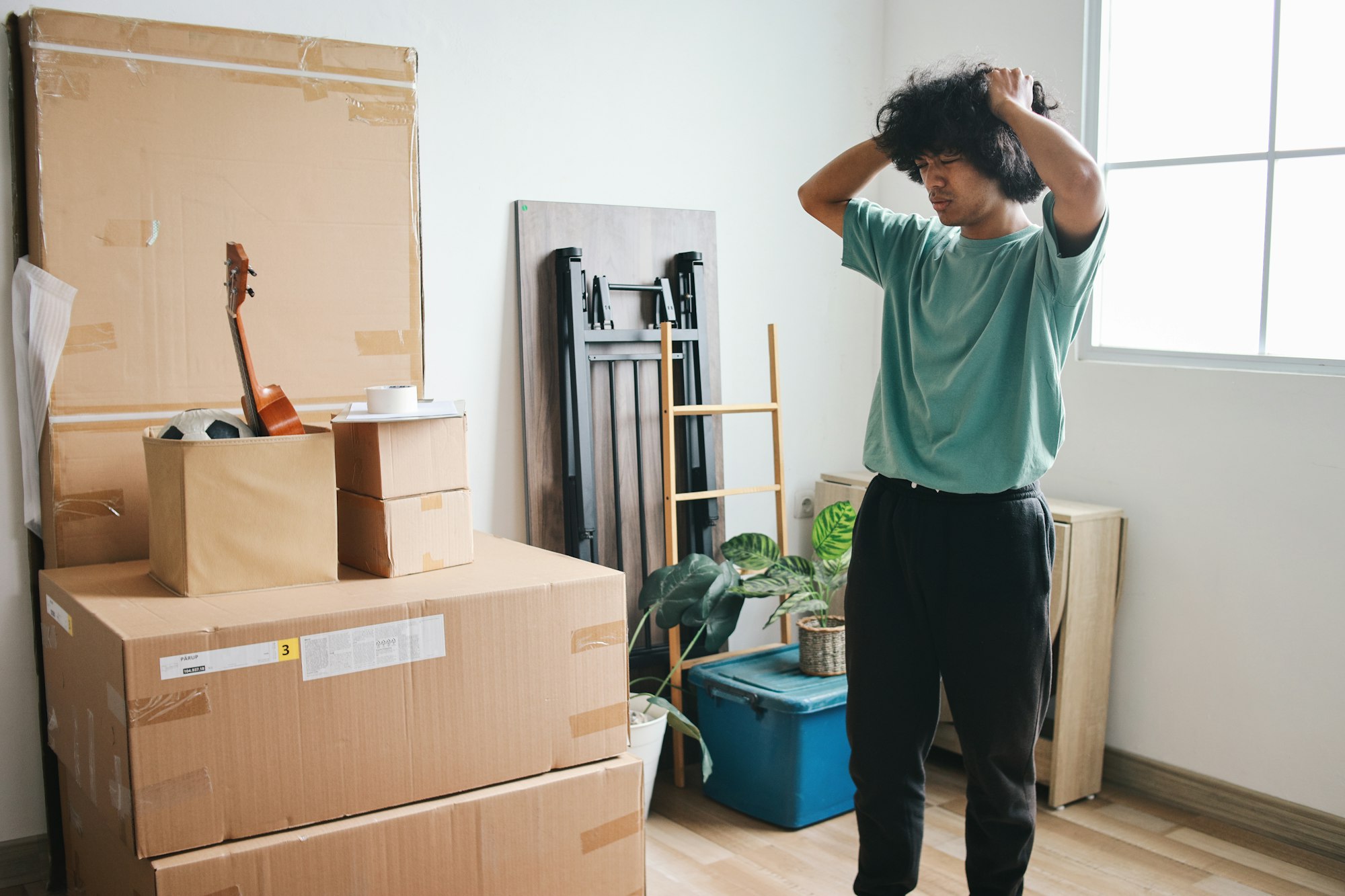 Stressed Man Moving House, Relocating Many Things with high moving costs