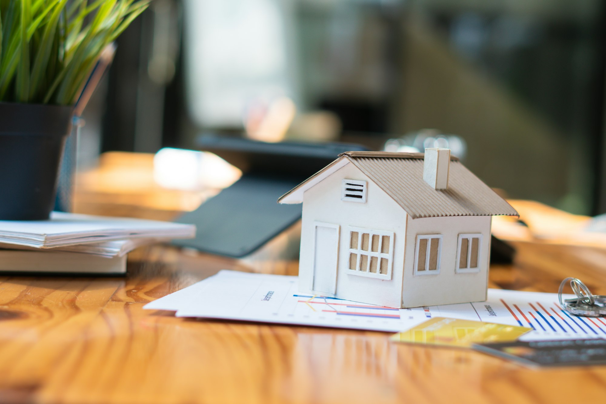 House model - risks of overpricing your home, contracts and wooden table